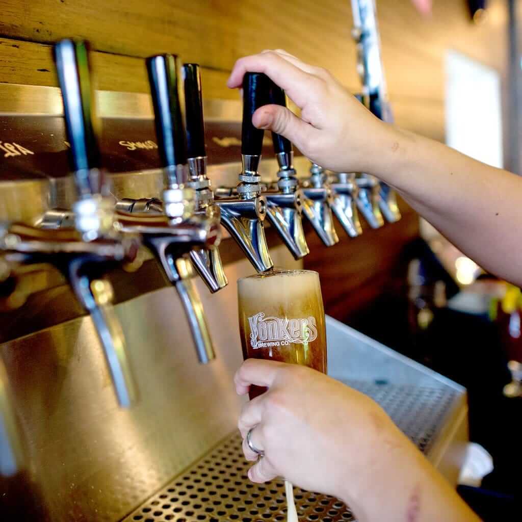 Draft beer pour into Yonkers Brewing Company glass